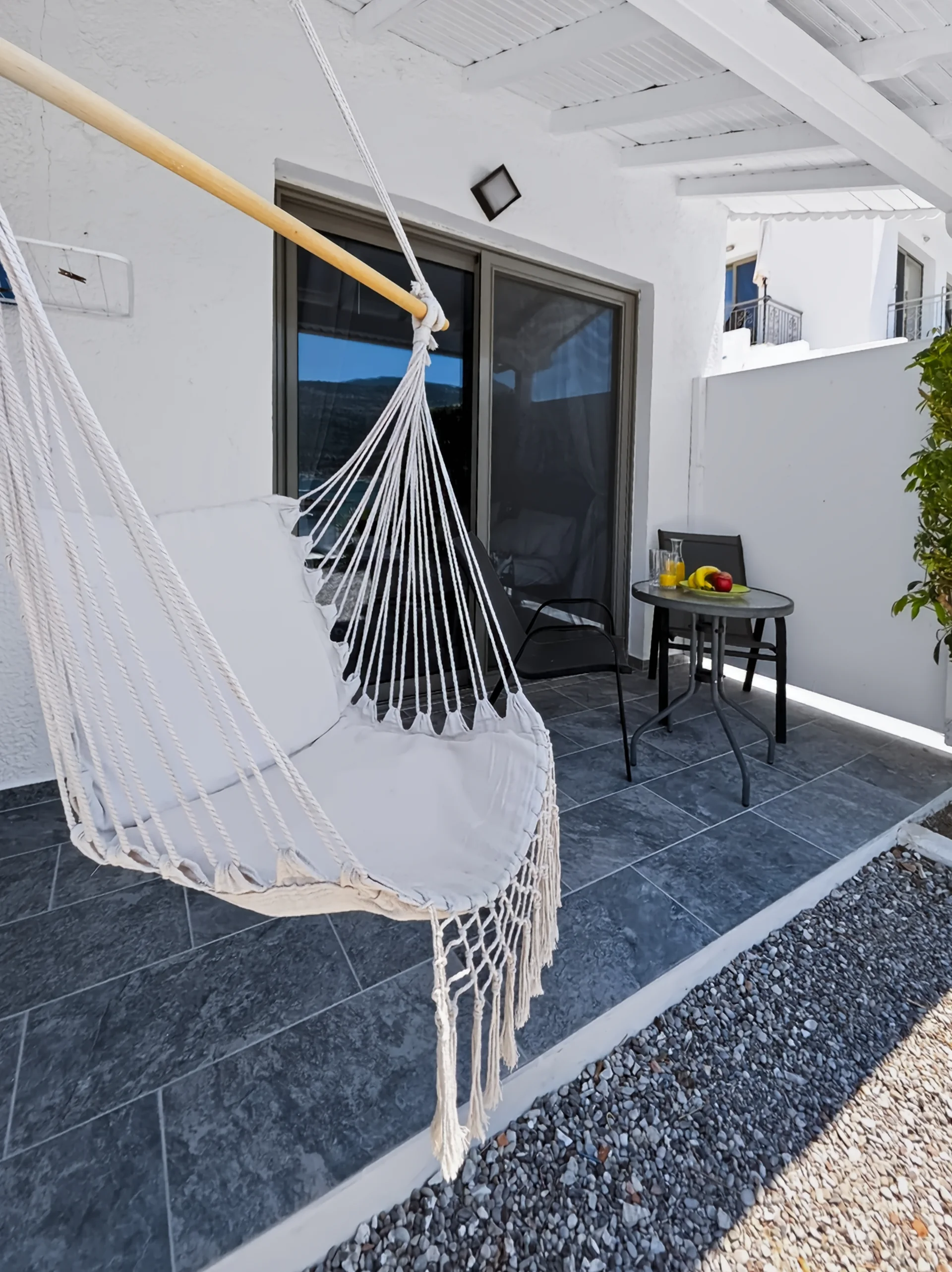 Studio 12: covered terrace with a hammock and Geni Bay view