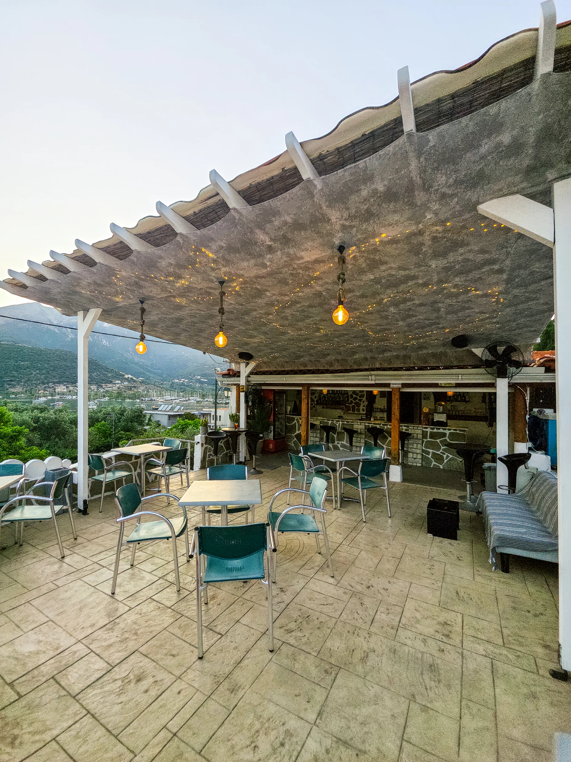 The open-air breakfast terrace and pool bar overlooking Geni Bay