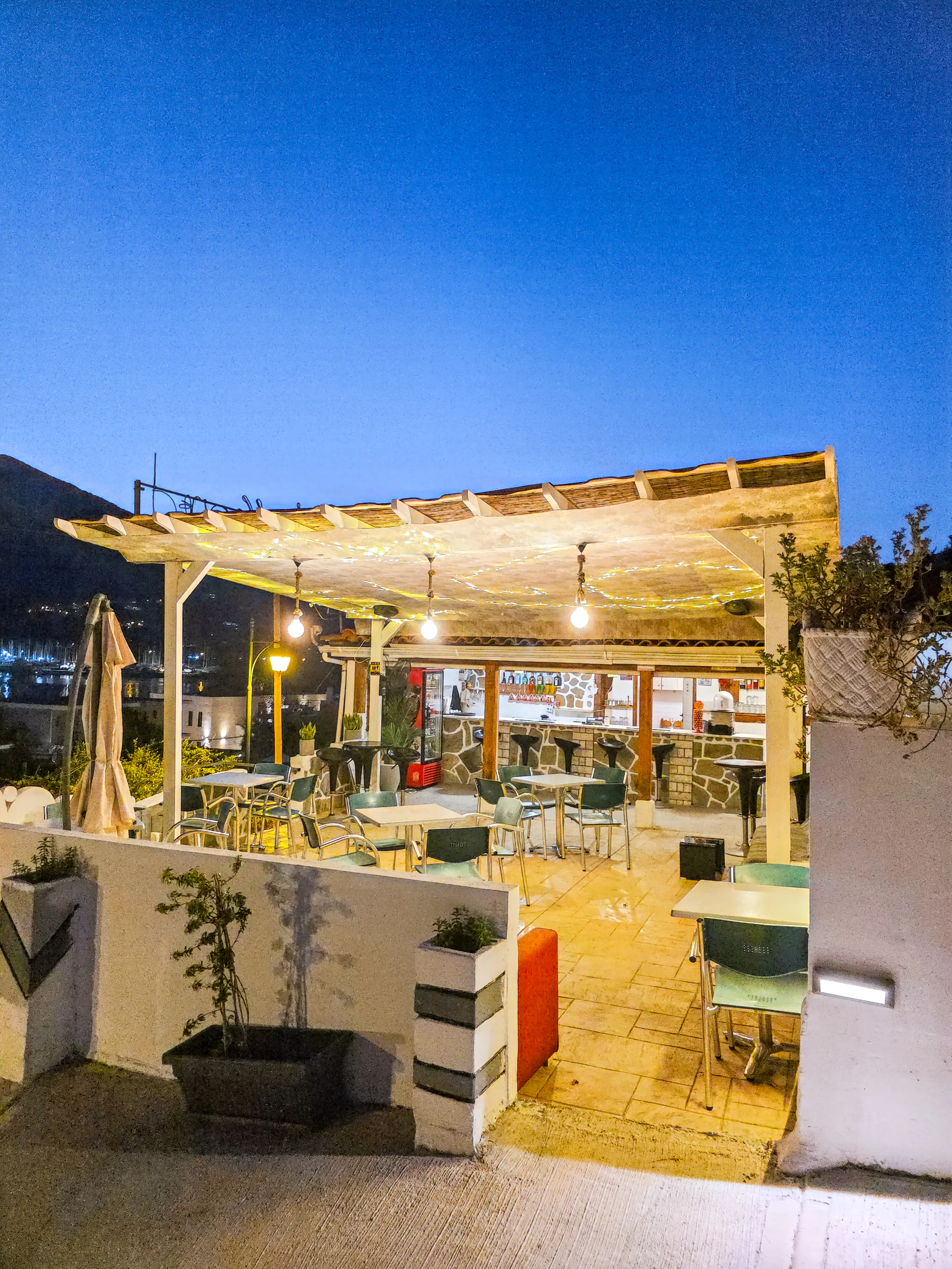 The illuminated pool bar terrace at Chakalaka Resort after sunset