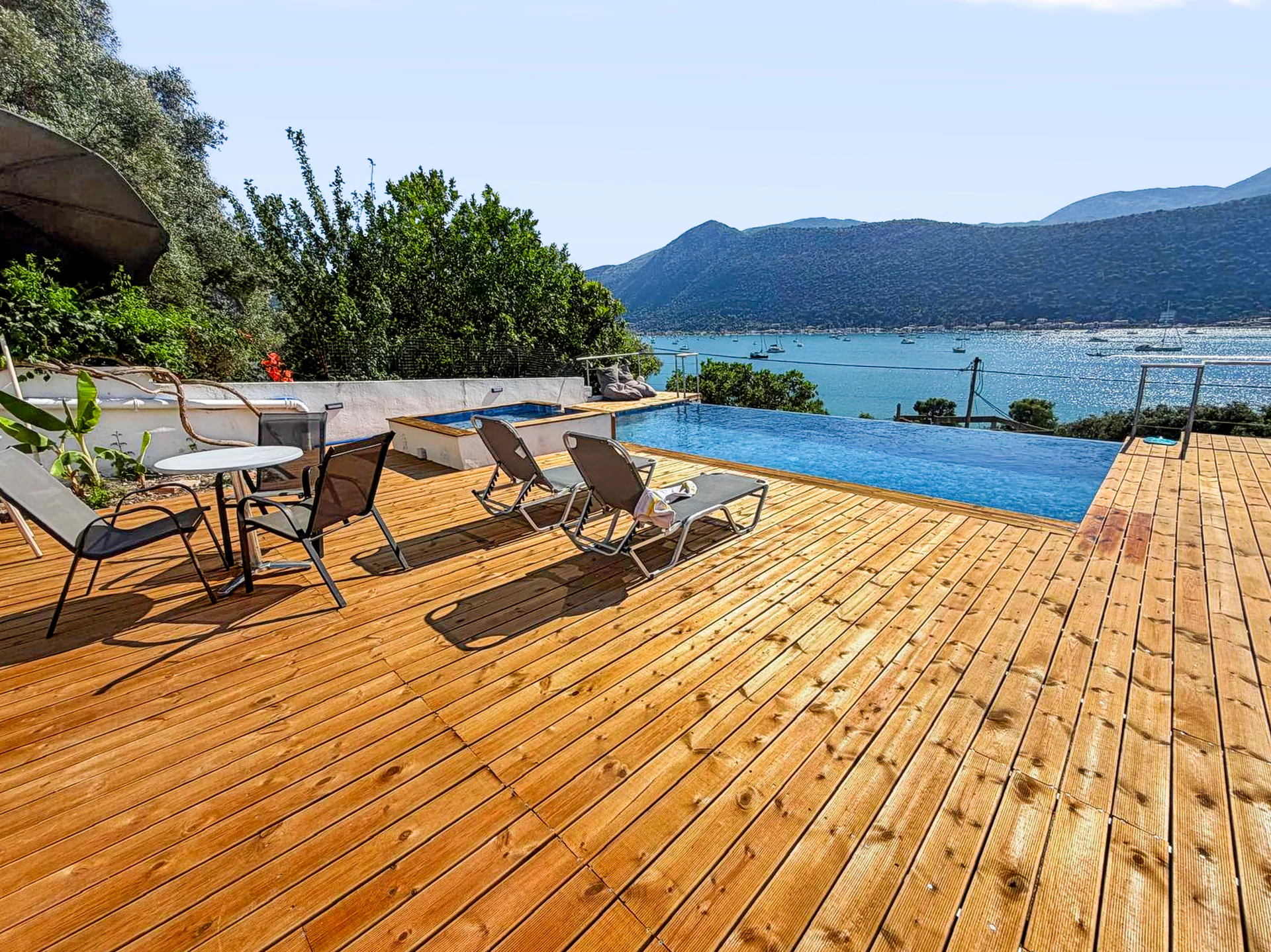 The sun deck, outdoor pool and wide view over Geni Bay at Chakalaka Resort